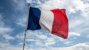 French Flag Waving Against Blue Cloudy Sky