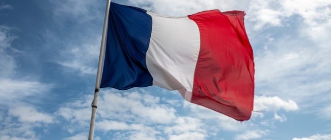 French Flag Waving Against Blue Cloudy Sky