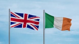 Flags of Britain and Ireland Against Light Blue Sky