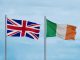 Flags of Britain and Ireland Against Light Blue Sky